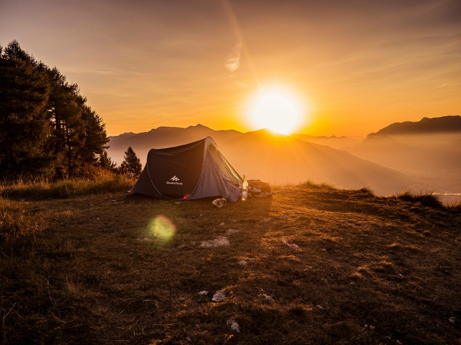 Tent on a mountain ridge at sunset