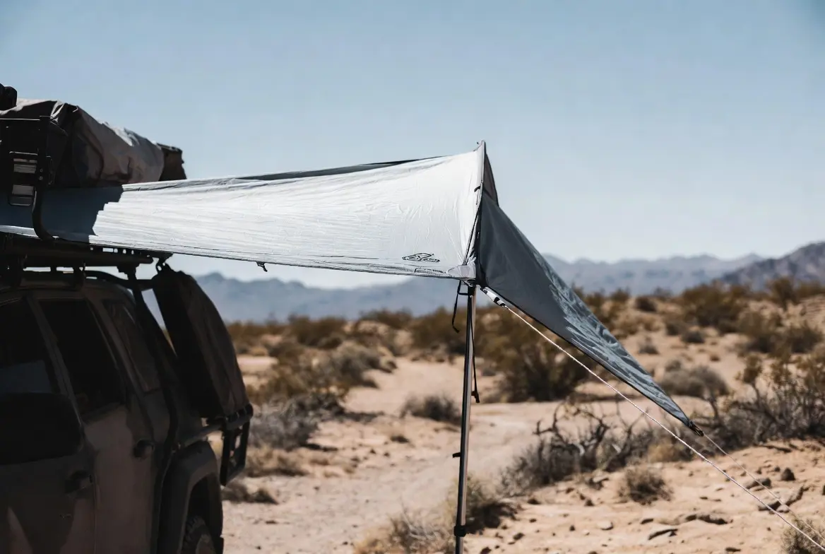 Vehicle awning deployed in the desert